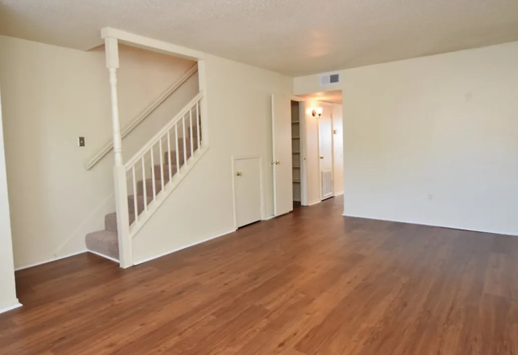 A room with a staircase and a door.